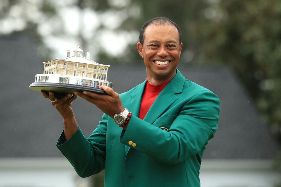 US Golfer Tiger Woods celebrates with the Masters Trophy during the Green Jacket Ceremony after winning the Masters.