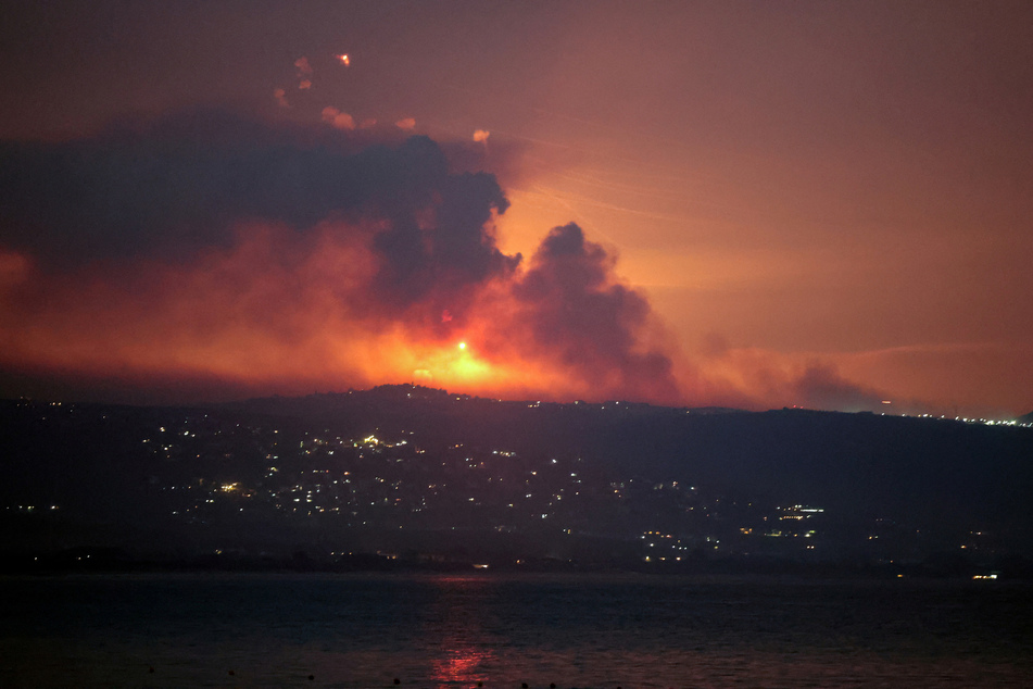 Smoke and fire are visible on the Lebanese side of the border with Israel, as pictured from Tyre, Lebanon, after Israel said it had carried out preemptive strikes.