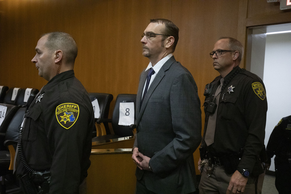 James Crumbley (c.), the father of a teen who purchased the gun that his son used in a deadly 2021 school shooting, was found guilty of involuntary manslaughter in a Michigan court on Thursday.