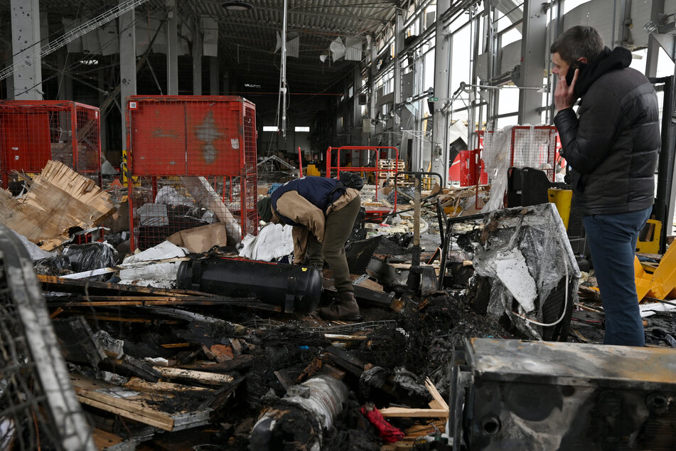Ukrainian police and prosecutors examine a damaged mail depot following missile strikes in the village of Korotych, Kharkiv region, amid the Russian invasion in Ukraine.