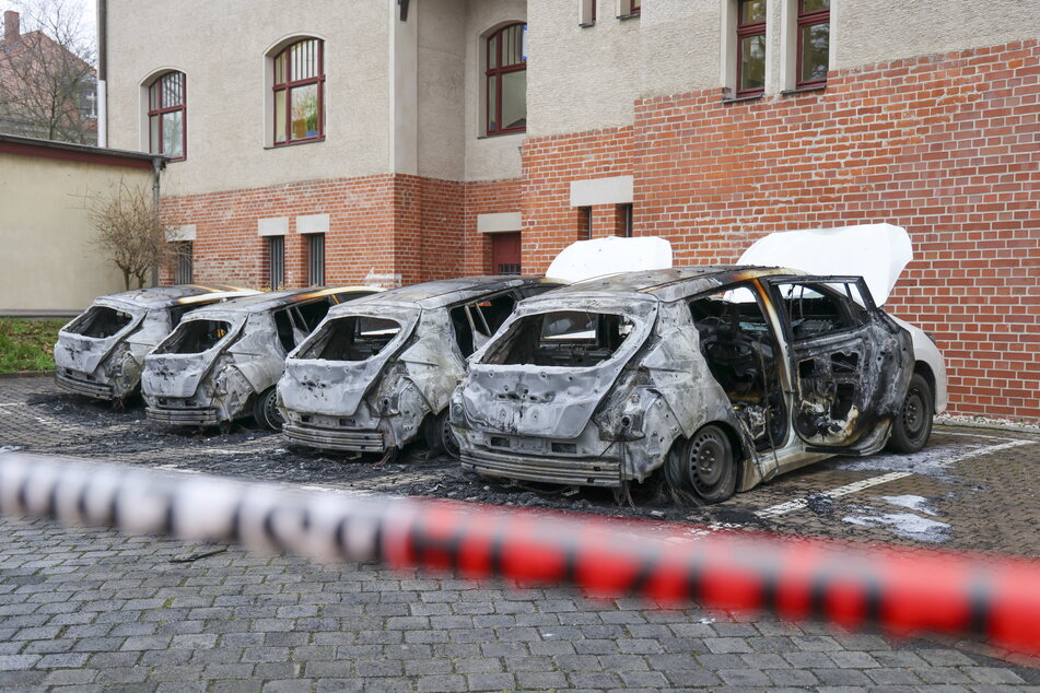 Brandanschlag: Die vier E-Autos der Leipziger Ortspolizeibehörde stehen ausgebrannt auf dem Hof des Schönefelder Rathauses.