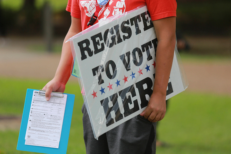 A University of Houston student helps fellow students on campus register to vote on September 30.