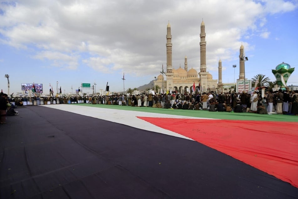 Yemenis unfurl a giant Palestinian flag during a rally in solidarity with Gaza and Lebanon in the capital of Sanaa on November 8, 2024.