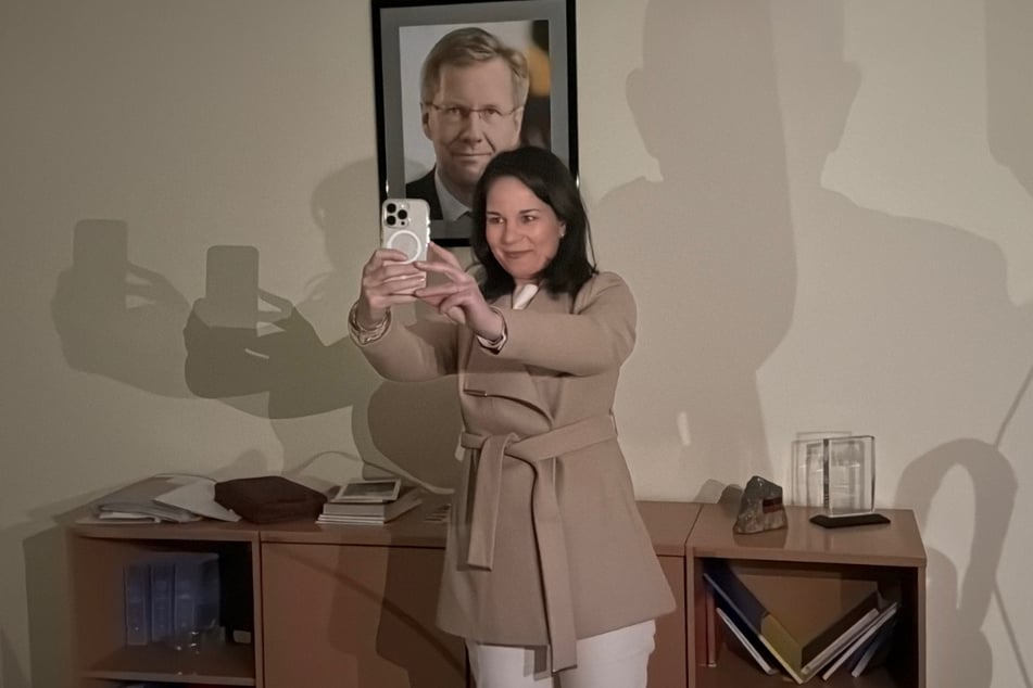 Annalena Baerbock (44) macht ein Selfie vor einem Portrait des ehemaligen Bundespräsidenten Christian Wulff (65).