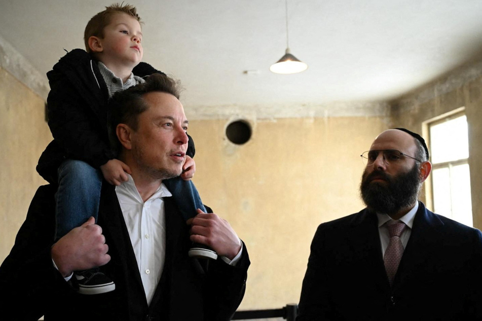 Elon Musk (l) brought his son as he took a tour of Auschwitz on Monday.