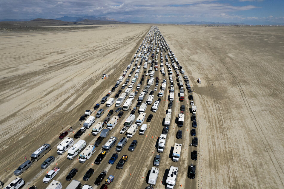 Vehicles are seen departing the Burning Man festival in Black Rock City, Nevada, on September 4, 2023.