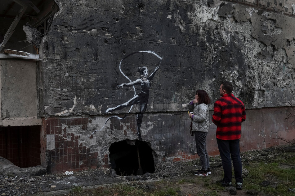 More street art was seen in Banksy's signature style on a wall of a destroyed building in the Ukrainian town of Irpin, which was heavily damaged by fighting in the early months of the Russian invasion.