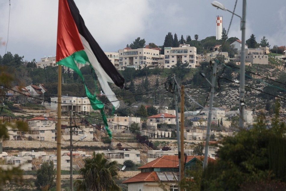 A picture taken in the village of Turmus Ayya near Ramallah city shows the nearby Israeli Shilo settlement in the background, in the occupied West Bank.