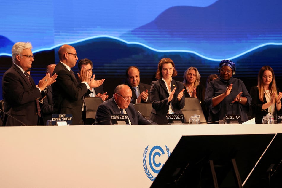 Delegates applaud as COP27 comes to a close on Sunday.