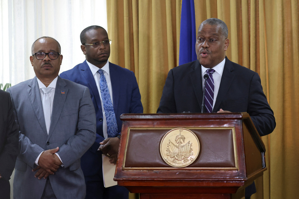 Garry Conille addresses the audience during a ceremony with members of the transition council, where he is presented as Haiti's interim Prime Minister.
