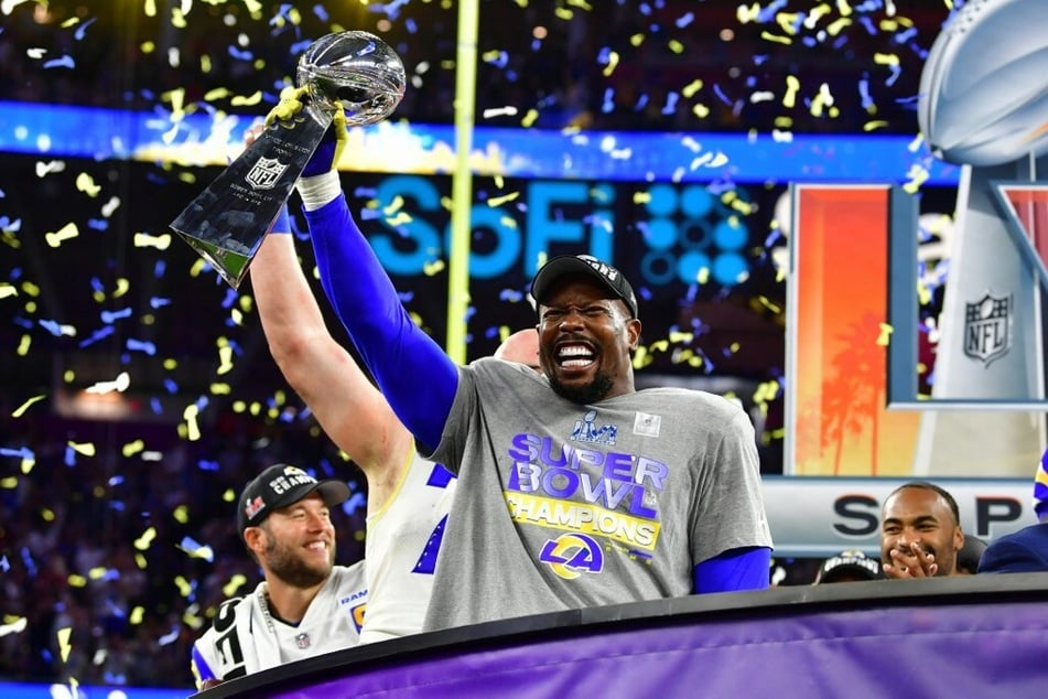 The Los Angeles Rams' Von Miller holds up the trophy after winning Super Bowl LVI against the Cincinnati Bengals.
