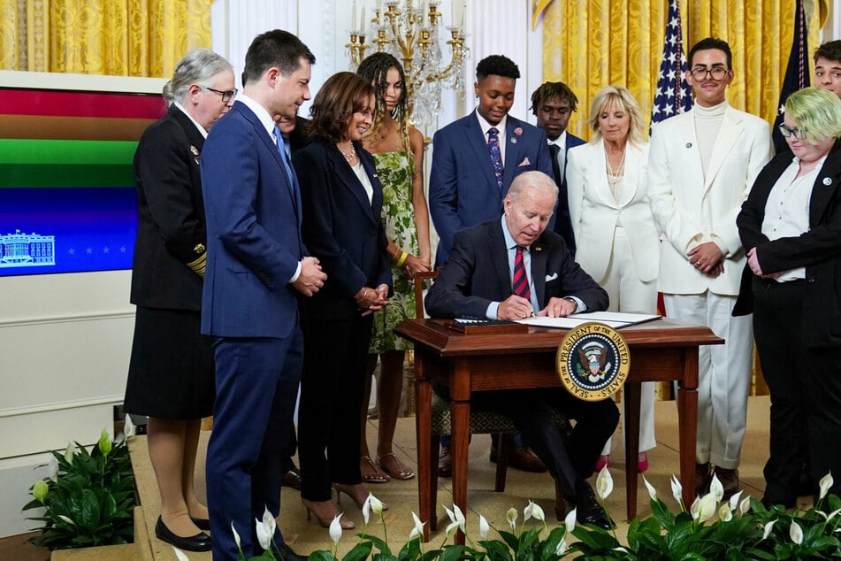 President Joe Biden signing executive orders aimed at strengthening LGBTQ+ rights.