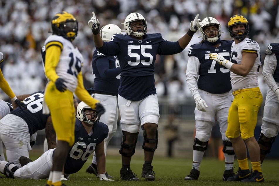 Anthony Whigan (c.) of the Penn State Nittany Lions celebrates after a play against the Michigan Wolverines when the two teams played last year.