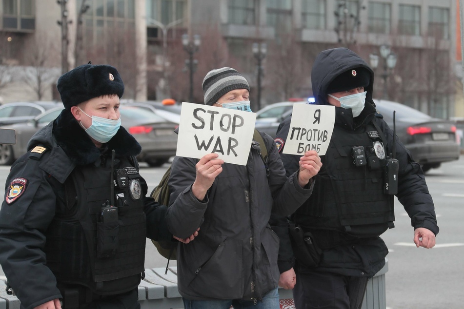 An anti-war protester in Pushkin Square, Moscow, being detained by police.