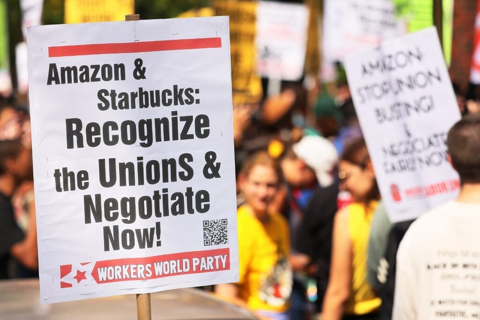 Pro-union protestors gather for a rally near the homes of Amazon CEO Jeff Bezos and Starbucks interim CEO Howard Schultz in New York City.