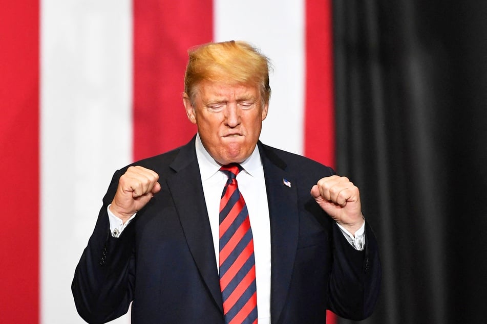 Donald Trump arrives on stage to speak at a rally at JQH Arena in Springfield, Missouri on September 21, 2018.