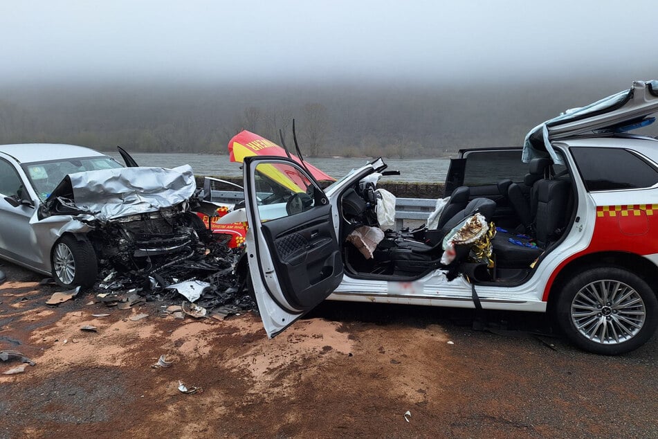 Das Einsatzfahrzeug (r.) wurde durch den massiven Unfall und die Rettungsmaßnahmen zerstört, wie die Feuerwehr später mitteilte.