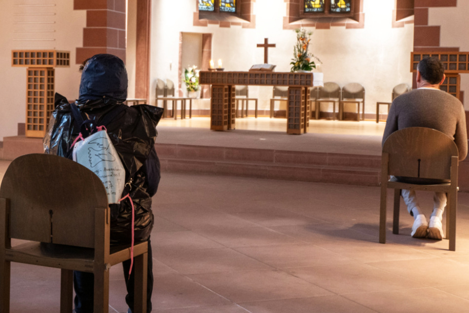 Weit voneinander entfernt sitzen Menschen im April in der Alten Nicolaikirche in Frankfurt und lauschen dem Spiel eines Organisten.