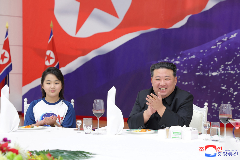 North Korea's leader Kim Jong-un attends a banquet to celebrate the launch of a reconnaissance satellite.