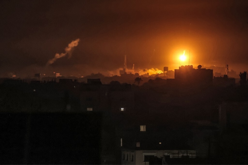 Israeli bombardment lights the skyline of Khan Younis, pictured from Rafah in the southern Gaza Strip late on January 7, 2024.