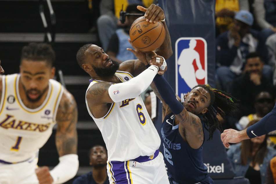 Los Angeles Lakers forward LeBron James and Memphis Grizzlies guard Ja Morant fight for control of the ball during the first half of Game 1.