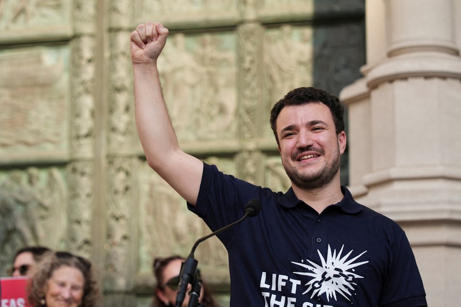 Mahmoud Khalil raises his fist during a rally to welcome him home after his release from immigration detention, outside the Cathedral of St. John the Divine in New York City, on June 22, 2025.