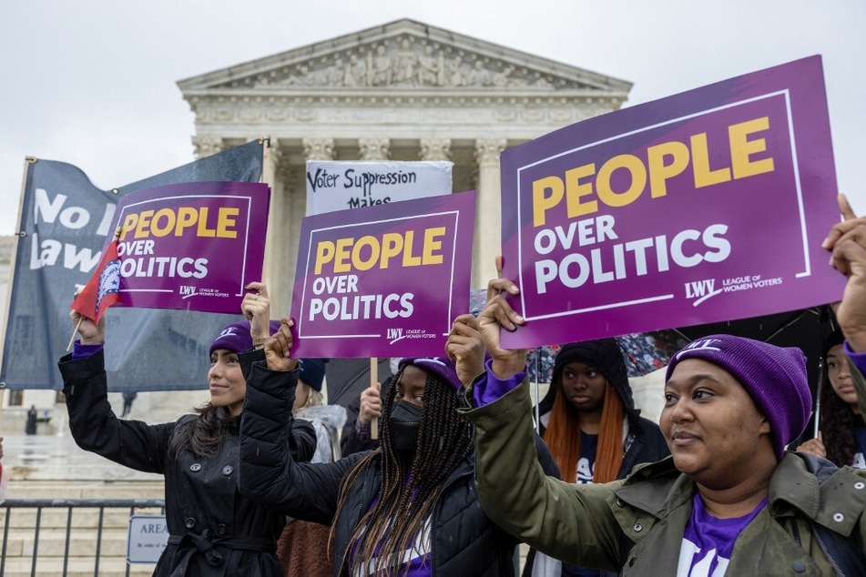 Demonstrators protest in a "No Lawless Lawmakers" rally at the Supreme Court during oral arguments in the Moore v. Harper elections case.