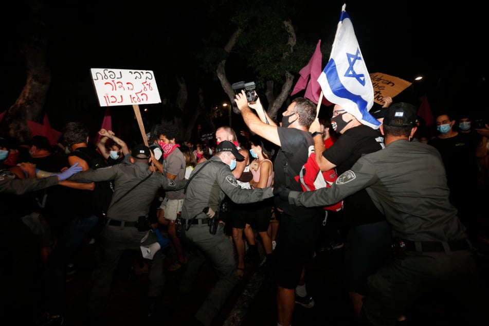 Polizisten stoßen in Tel Aviv mit Demonstranten zusammen, die trotz eines landesweiten Lockdowns aufgrund der Corona-Pandemie gegen den Premierminister Netanjahu protestieren.