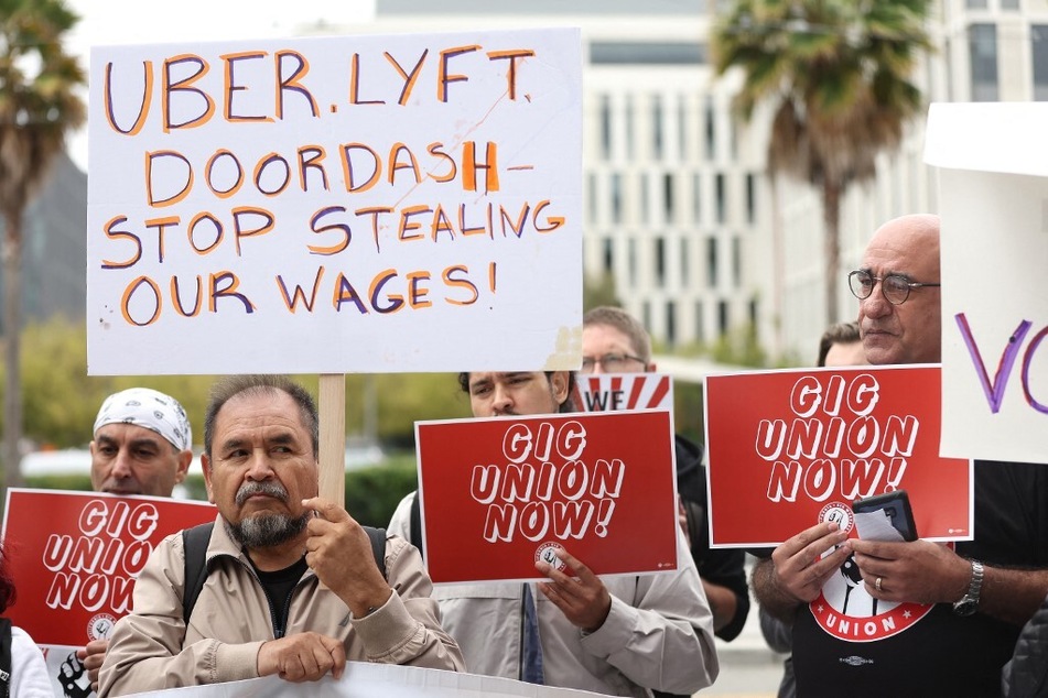 Dozens of gig workers and delivery drivers stage a protest outside the Uber headquarters in San Francisco to announce the formation of the California Gig Workers Union.