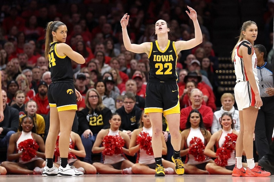 College basketball fans didn't hold back in their comments about Caitlin Clark (c) and her post-game "flop."