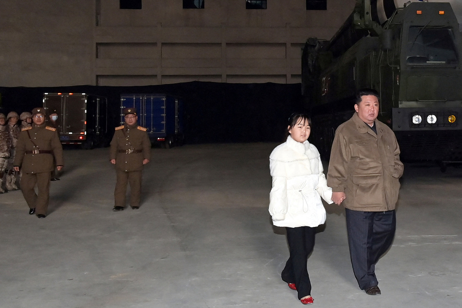 North Korea threatens nuclear retaliation as Kim Jong Un reveals daughter at missile launch