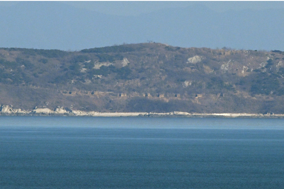 A view of North Korea's coastline with artillery bunkers from Yeonpyeong island, where North Korea fired over 60 artillery rounds on Saturday, according to Seoul's military.