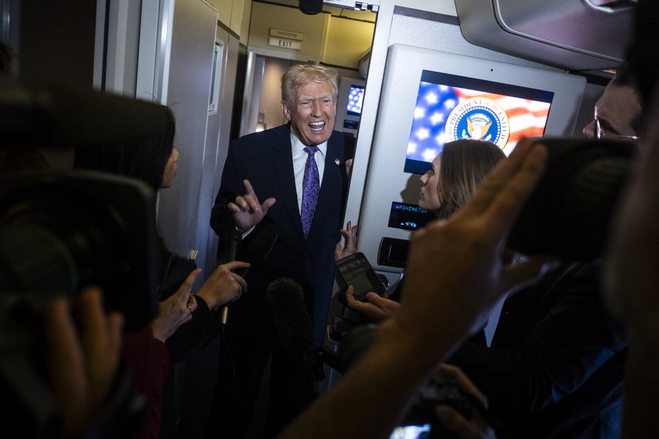 President Donald Trump speaks to the press aboard Air Force One en-route to Washington DC on November 30, 2025.