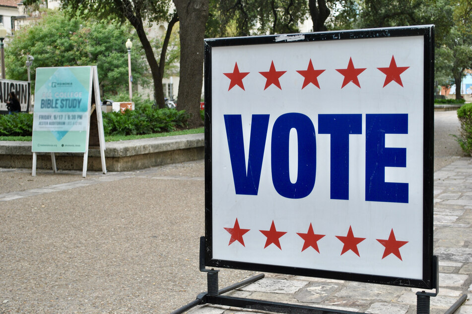 A large voting sign stands outside a polling location on the University of Texas campus in Austin, Texas.