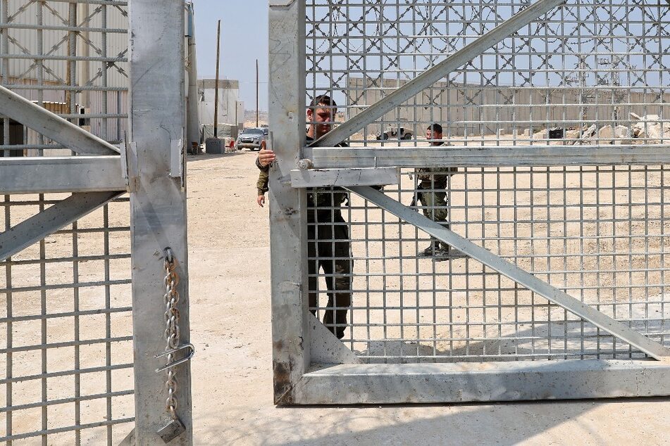 Israeli soldiers open a gate at the Erez crossing between Israel and Beit Hanun in the northern Gaza Strip during a humanitarian aid delivery operation.