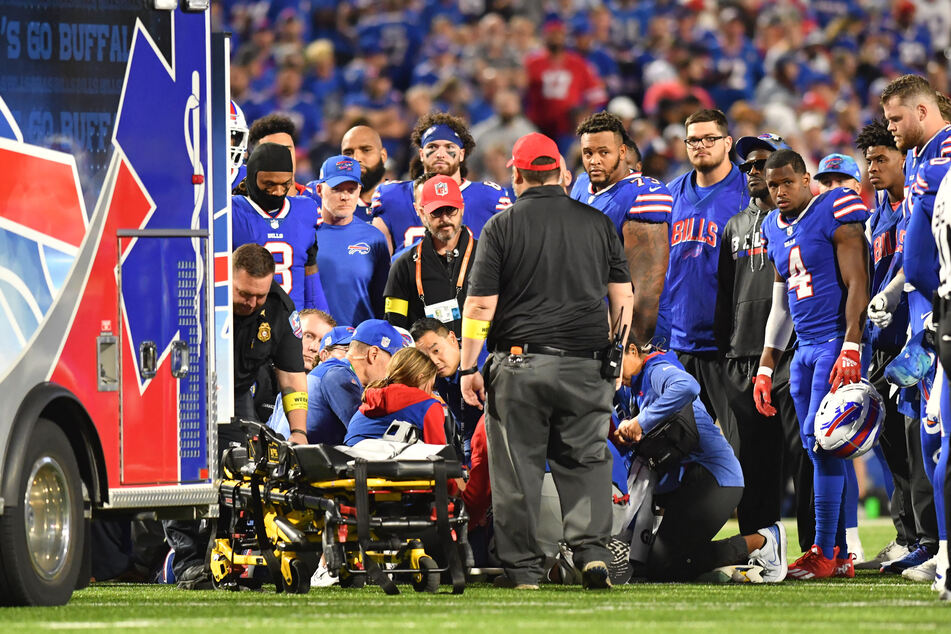 Buffalo Bills platers and coaches stand around medical personnel attending to Buffalo Bills cornerback Dane Jackson in the second quarter at Highmark Stadium.