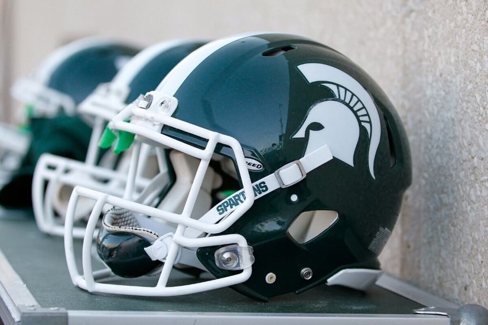 Michigan State Athletics suspended four football players on Sunday for their involvement in a frightening brawl at Michigan Stadium on Saturday night