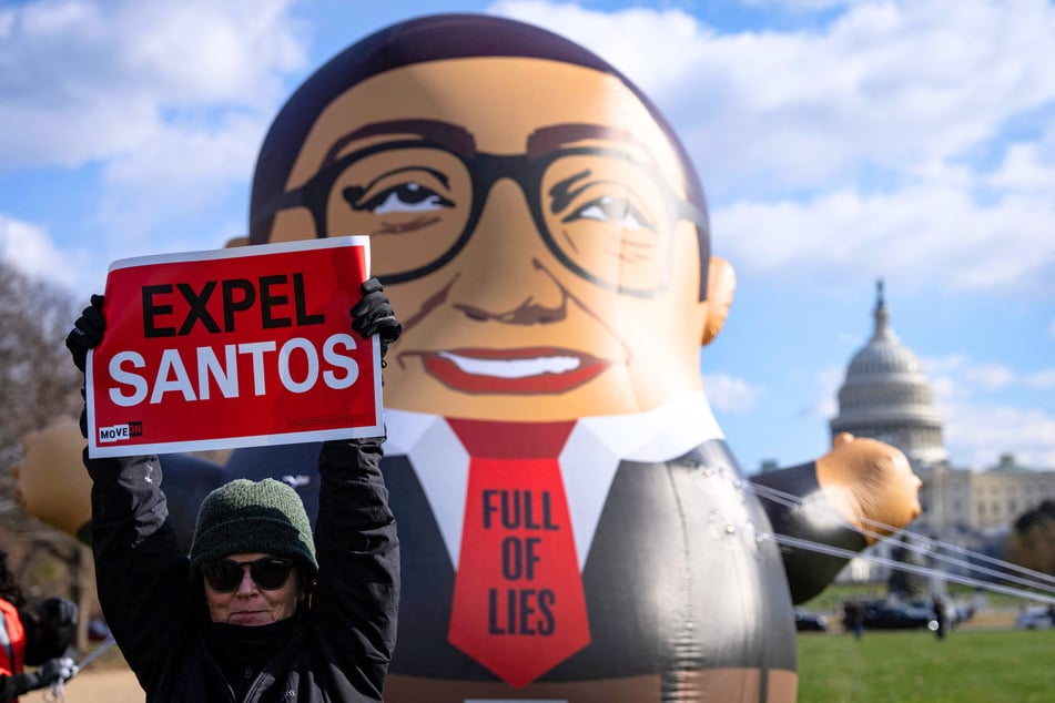 Activists with MoveOn display a 15-foot inflatable of George Santos as they call for his expulsion from Congress on Capitol Hill in Washington DC on November 28, 2023.