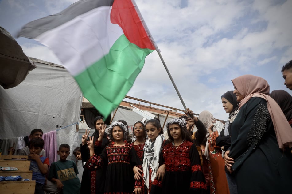 Palestinians in Gaza celebrate as a ceasefire agreement between Israel and Hamas is announced.