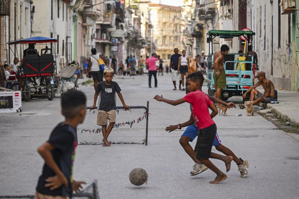 Children play football on the streets of Havana during a nationwide blackout on July 14, brought on by the US' brutal fuel embargo of Cuba.