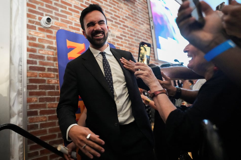 Zohran Mamdani interacts with supporters during a watch party for his successful mayoral primary election.