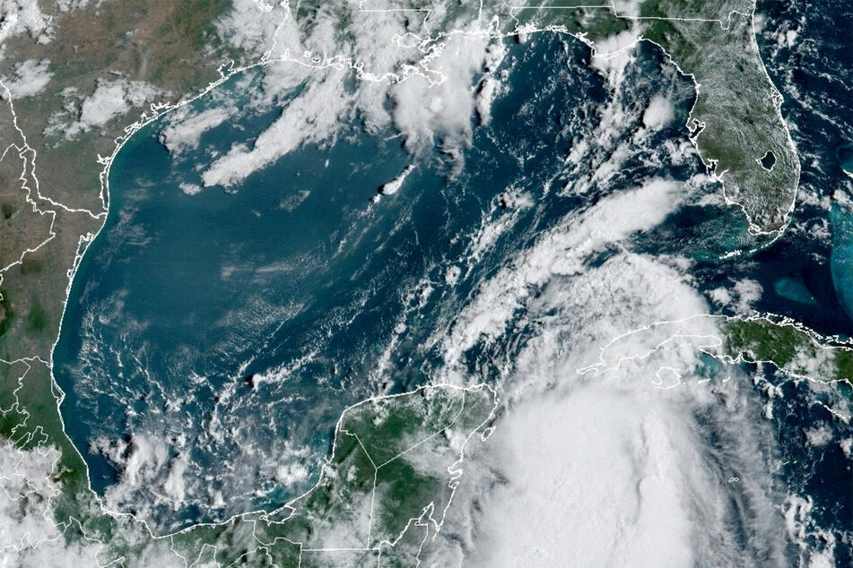 Tropical Storm Idalia makes its way to Cuba and Florida's west coast in a composite image from the National Oceanic and Atmospheric Administration GOES-East weather satellite on August 28, 2023.