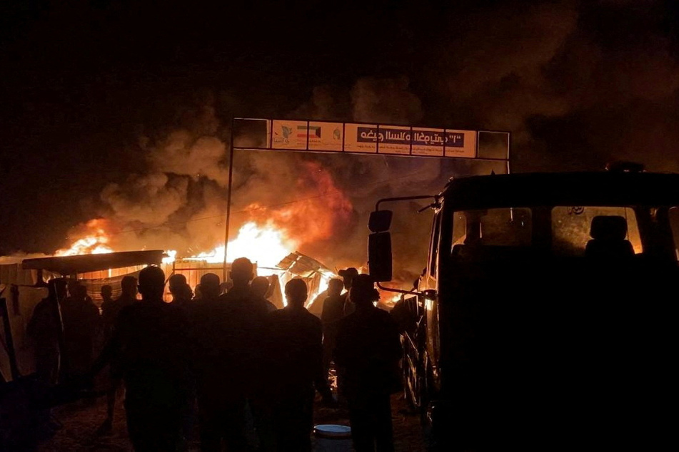 Fire rages following an Israeli strike on an area designated for displaced Palestinians, in Rafah in the southern Gaza Strip.