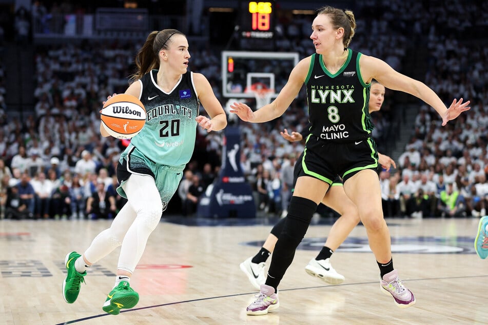 New York Liberty guard Sabrina Ionescu works around Minnesota Lynx forward Alanna Smith during the second half of game three of the 2024 WNBA Finals at Target Center.