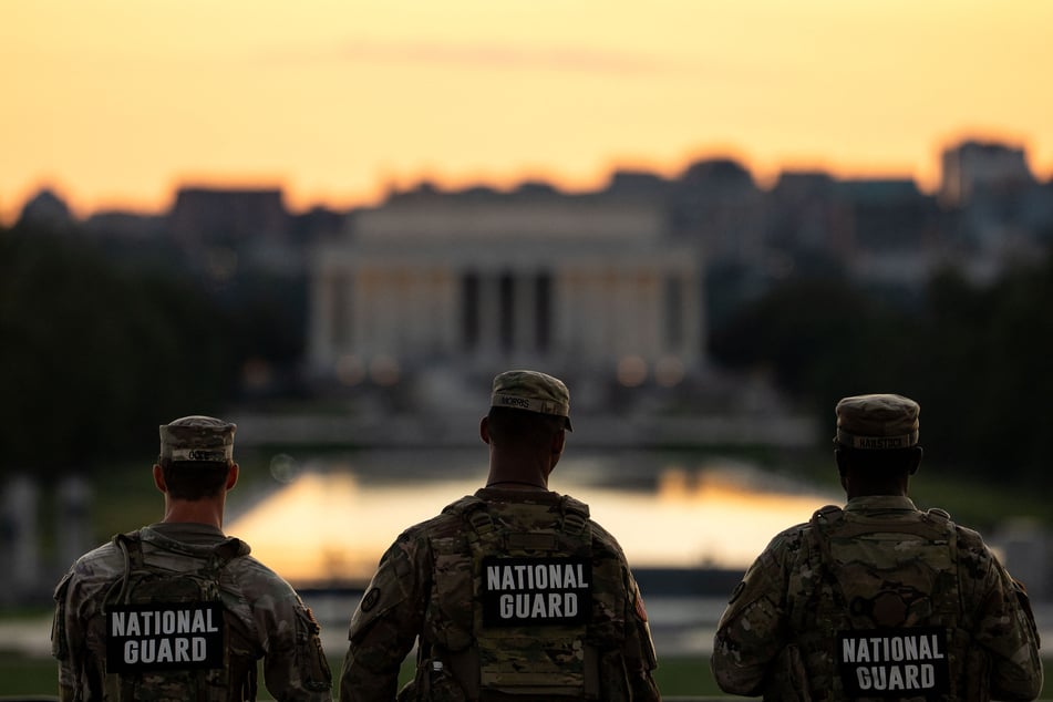 Members of the National Guard are seen standing near the Washington Monument on Tuesday in Washington, DC.