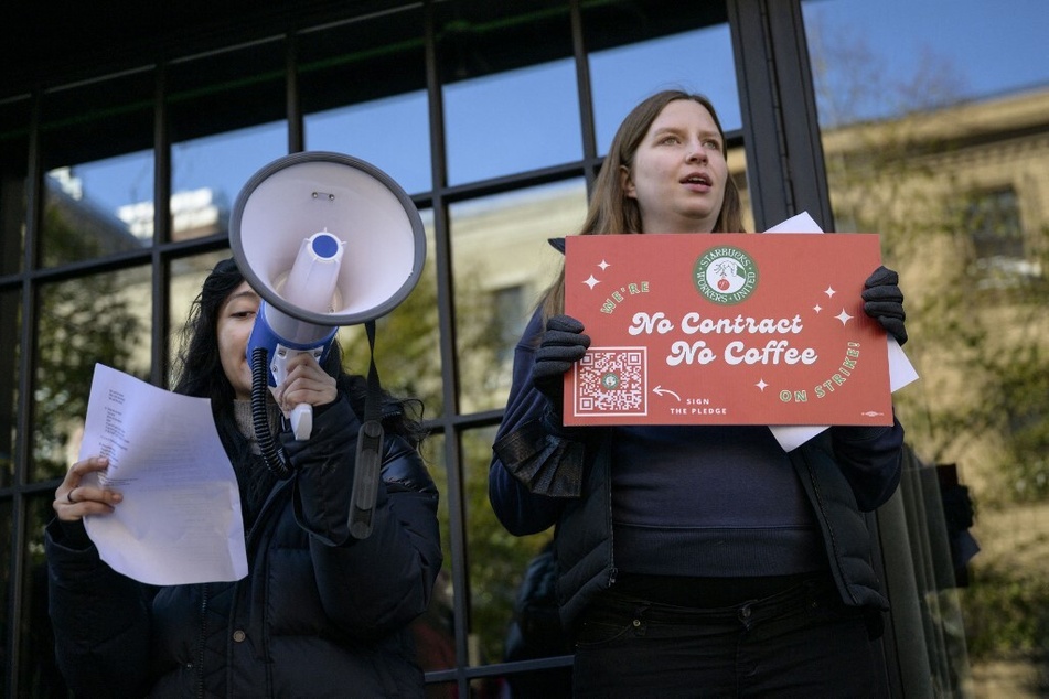Starbucks workers hold signs reading "No Contract, No Coffee" during a strike outside a coffee shop in the Brooklyn borough of New York City.