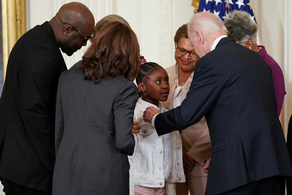 President Biden speaks with George Floyd's daughter Gianna Floyd after signing an executive order on policing.