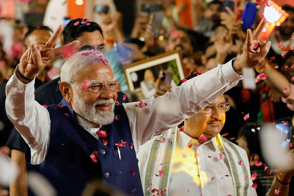 Indian Prime Minister Narendra Modi celebrates as he arrives at the Bharatiya Janata Party headquarters in New Delhi.