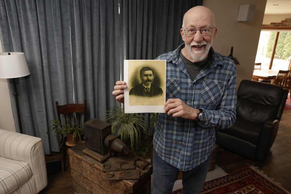 Bill McFarland holds up a photo of his great-grandfather William DeLyle Frisbee at his home in Jenison, Michigan, on March 31, 2026.