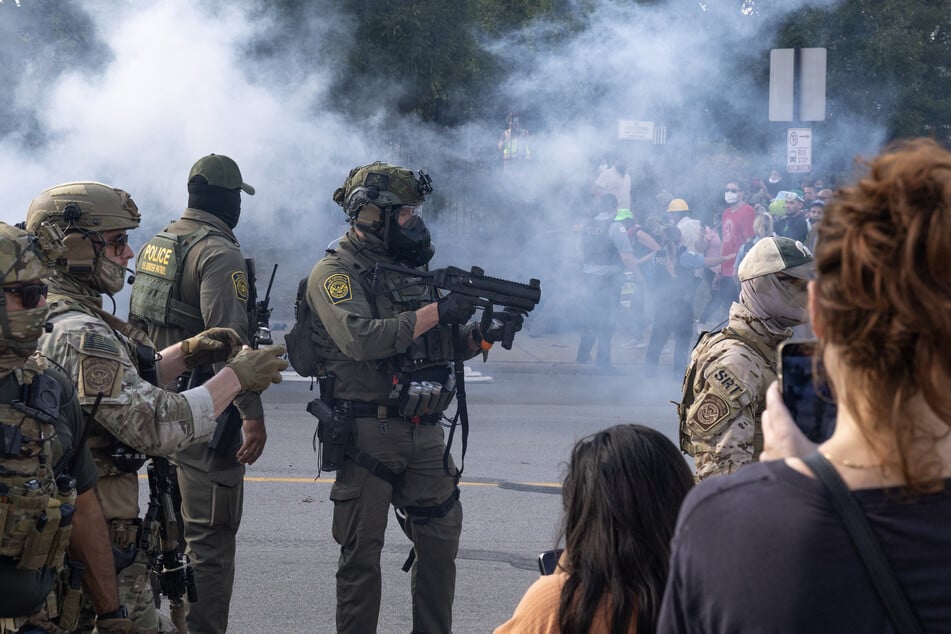 Tear gas fills the air after it was used by federal law enforcement agents who were being confronted by community members and activists for reportedly shooting a woman in the Brighton Park neighborhood in Broadview, Illinois, on October 4, 2025.